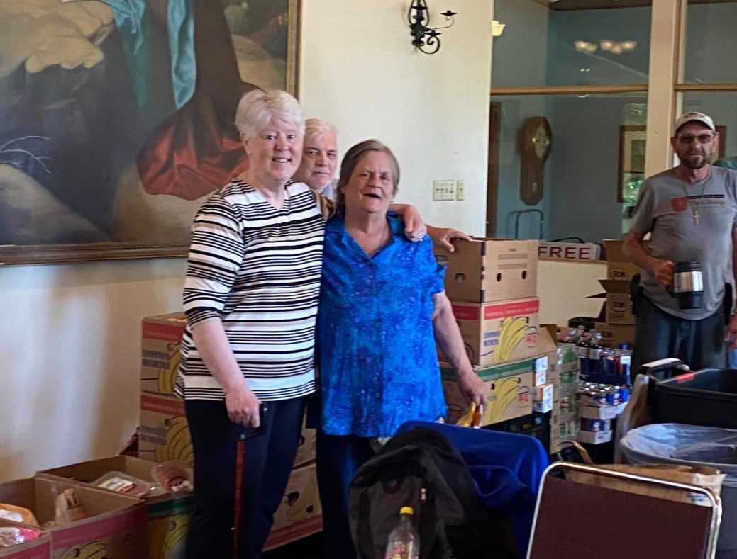 Volunteers and neighbors sharing a warm moment at Zion Lutheran Church