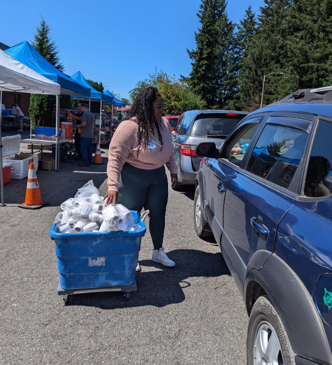 Volunteer serving cars at a distribution